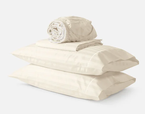 Front view of the contents for our Cream Luxor Egyptian Cotton Sheet Set stacked and folded.