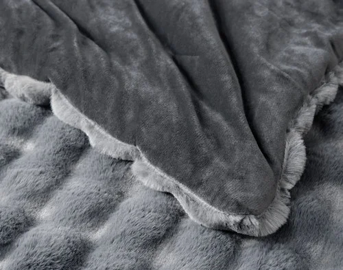 Close-up on the folded corner of our Granite Bubble Faux Fur Comforter Set to show its smooth velvet backing.