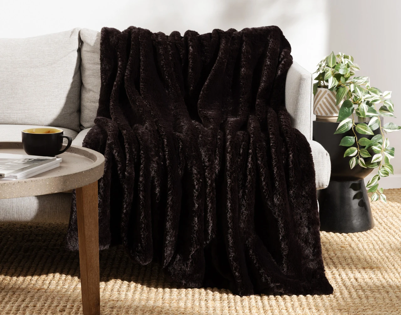 Front view of our Espresso Poodle Faux Fur Throw draped over a couch.