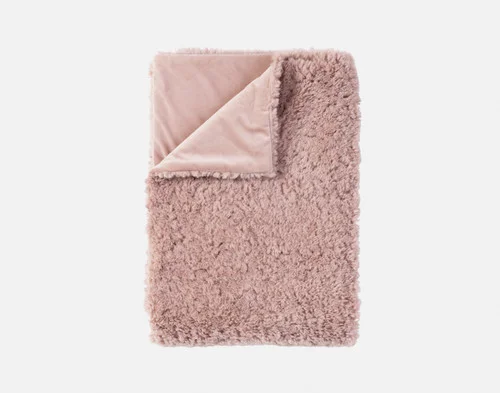 Our Dusty Rose Poodle Faux Fur Throw neatly folded.