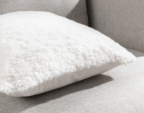 Close-up of the corners and edge on our Ivory Poodle Faux Fur Square Cushion.
