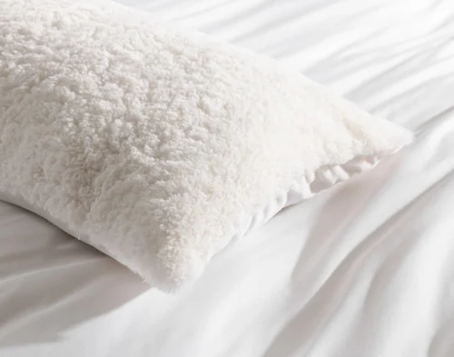Close-up of the edges on the corner of our Ivory Poodle Faux Fur Lumbar Pillow.