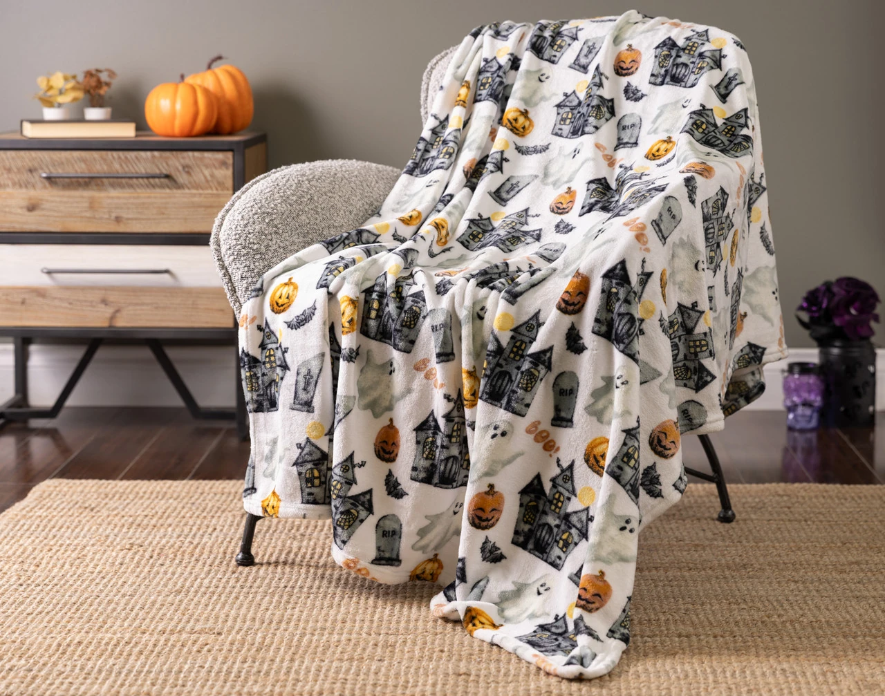 Our Haunted Mansion Halloween Fleece Throw draped over a chair.