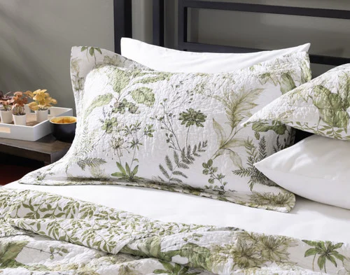 Our Verdelle Cotton Quilt Set dressing the head of a bed.