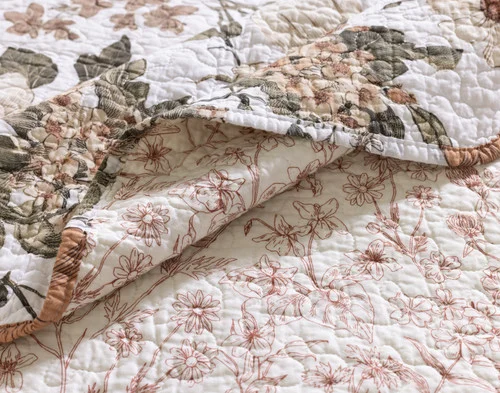 Our folded Carmine Cotton Quilt Set showing the front and reverse patterns.