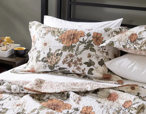 Our Carmine Cotton Quilt Set dressing the head of a bed.