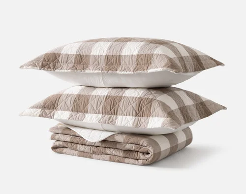 Contents of our Wellington Ash Cotton Quilt Set resting on a solid white background, including a quilt and two pillow shams.