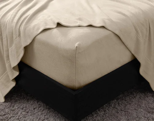 Close-up on the corner of our Cuddle Fleece Sheet Set in Oakwood with its fitted sheet wrapped around a queen mattress.