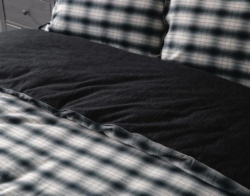 Angled view of our Bailey Duvet Cover Set dressing the head of a bed.
