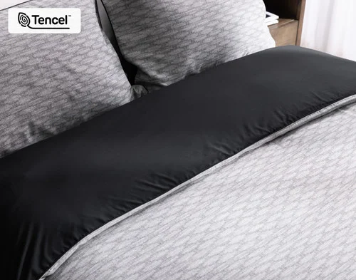 Angled view of the head of a bed dressed in our Metric collection.