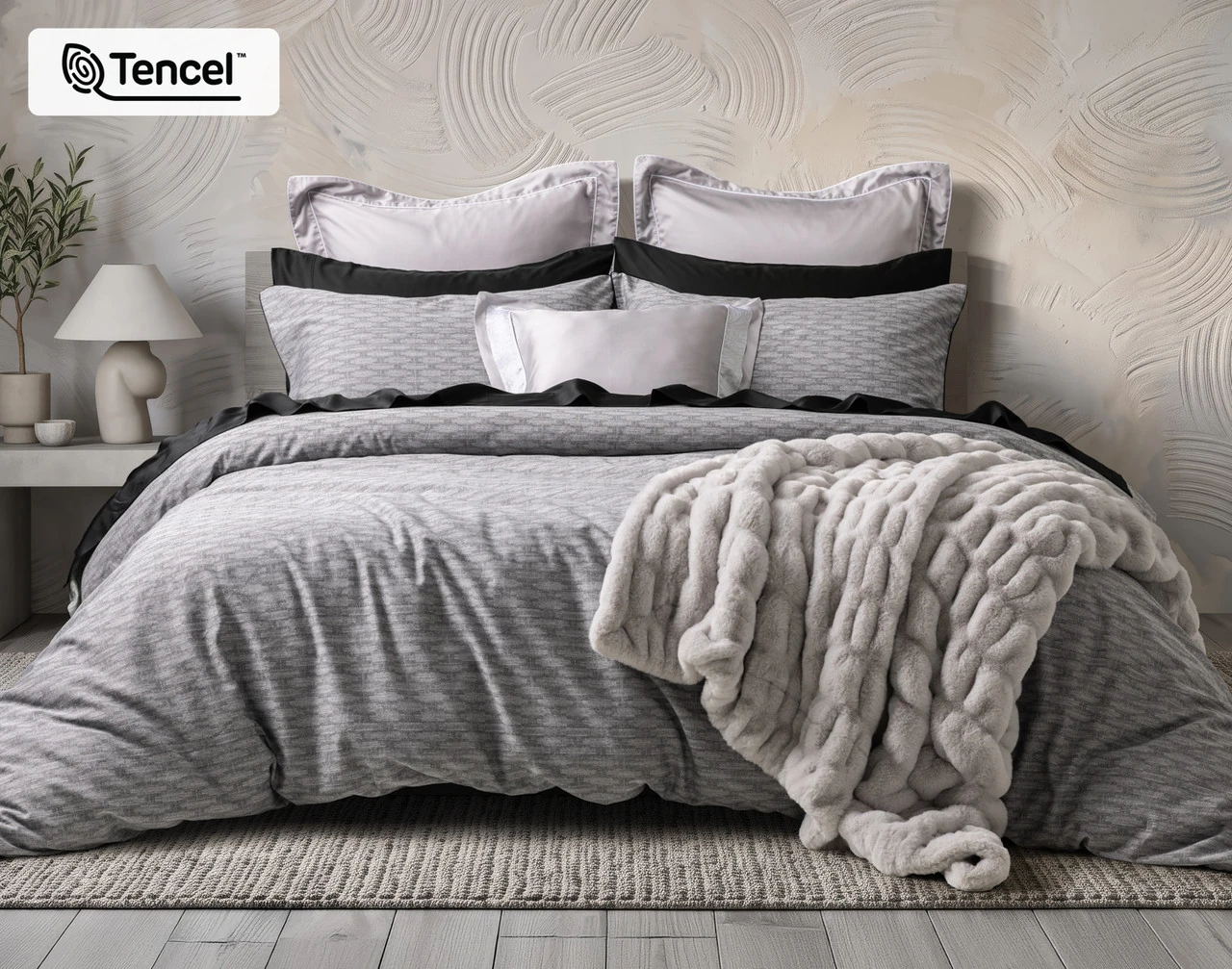 Front view of our Metric Duvet Cover dressed with accessories in a beige room.