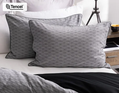 Our Metric Pillow Shams decorating the head of a bed.