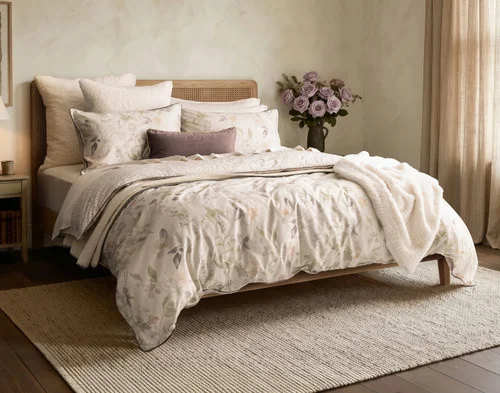 Angled view of our Elodie Duvet Cover dressing a queen bed with accessories.