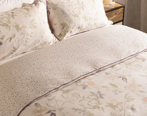 Angled view of our Elodie Duvet Cover dressing the head of a bed.