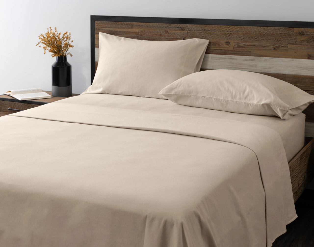 Angled view of our Toasted Oat Flannel Sheet Set dressed over an empty queen bed.
