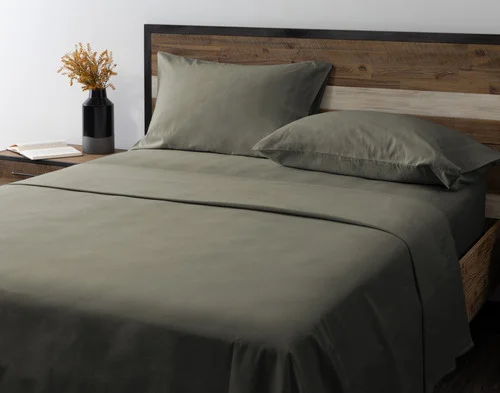 Angled view of our Alpine Forest Flannel Sheet Set dressed over an empty queen bed.