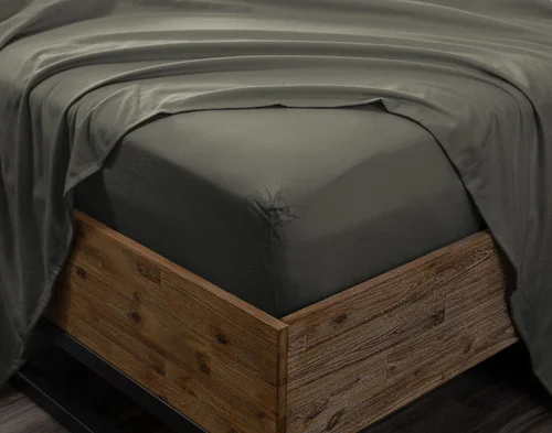 Angled view of the corner on a mattress wrapped in our Alpine Forest Flannel Sheet Set.