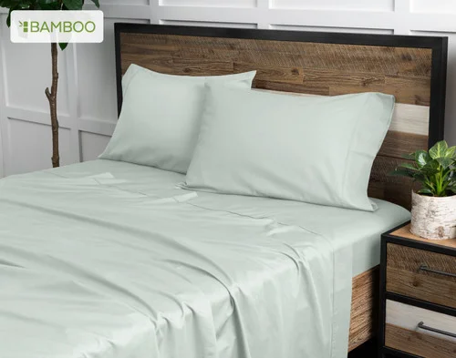 Angled view of our Bamboo Cotton Sheet Set in Aqua Smoke dressing a bed in a simple bedroom.
