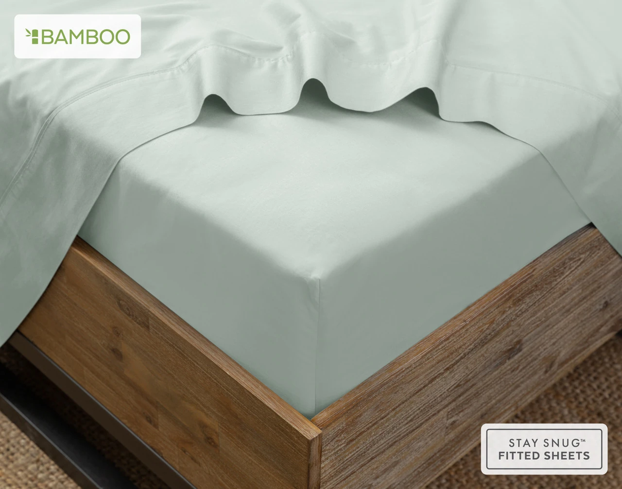 Our Bamboo Cotton Fitted Sheet in Aqua Smoke on the corner of a bed with our Bamboo Cotton Flat Sheet in Aqua Smoke.