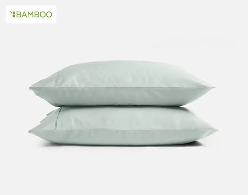 Our Bamboo Cotton Pillowcases in Aqua Smoke stacked on a white background.