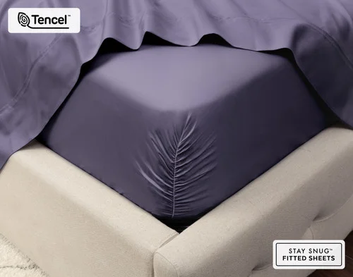Close-up on the corner of our Eucalyptus Luxe Sheet Set in Purple Basil fit over a queen mattress.