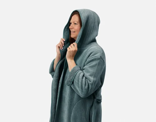 Closer view of woman wearing our Chenille Sherpa Bathrobe in Juniper against a solid white background with hood raised over her head.