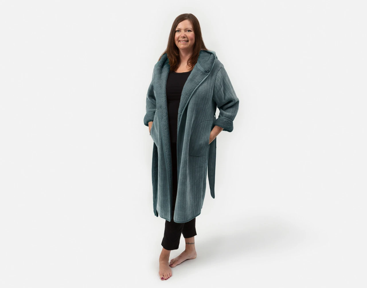Front view of woman wearing our Chenille Sherpa Bathrobe in Juniper against a solid white background.