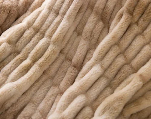 Close up on our Cocoon Plush Throw in Caramel to show its textured surface.