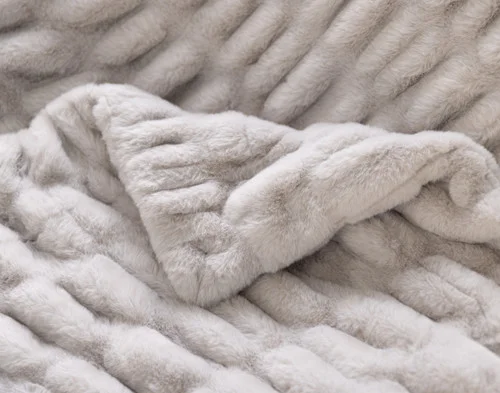 Close up on the folded surface of our Cocoon Plush Throw in Silver to show its textured surface.