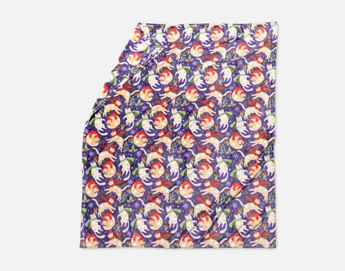 Our Holiday Fleece Throw - Festive Felines lying with a fold against a white background.
