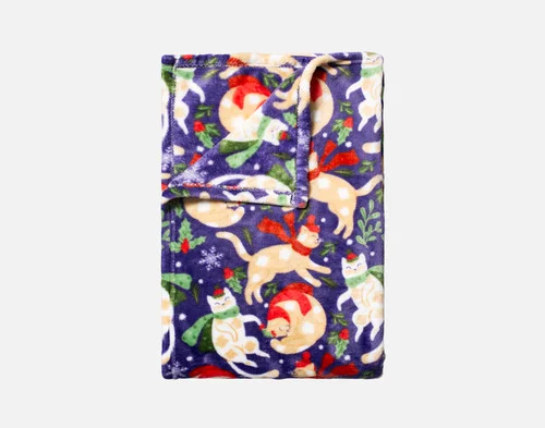 Our Holiday Fleece Throw - Festive Felines folded into a rectangle against a white background.