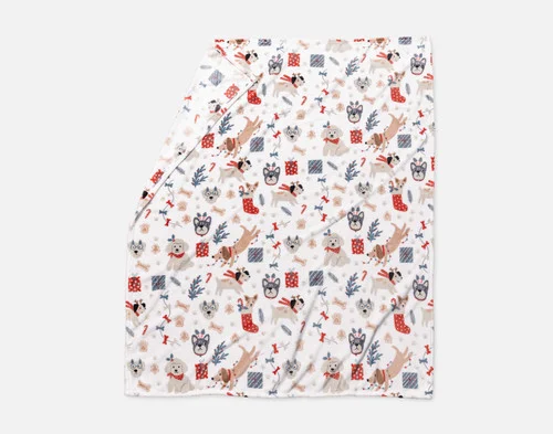 Our Holiday Fleece Throw - Cozy Canines lying with a fold against a white background.