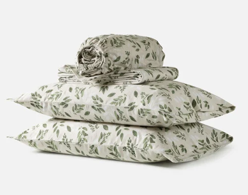 The contents of our Woodmere Organic Cotton Flannel Sheet Set, including two pillowcases, a fitted sheet, and a flat sheet.