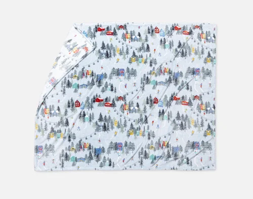 Our Holiday Fleece Throw - Alpine Retreat lying with a fold against a white background.