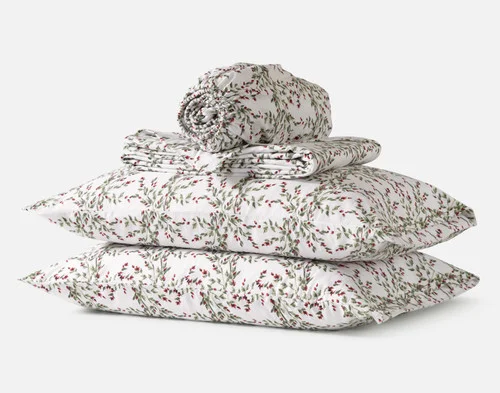 The contents of our Rosehip Grove Organic Cotton Flannel Sheet Set, including two pillowcases, a fitted sheet, and a flat sheet.