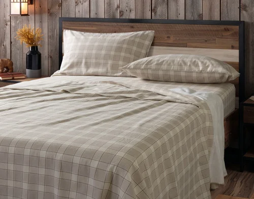 Our Cabin Check Organic Cotton Flannel Sheet Set dressed over a plain queen bed.