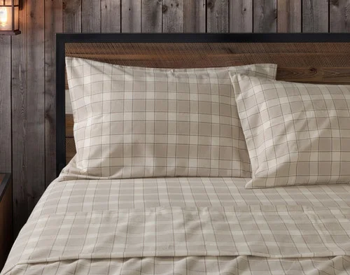 Front view of two pillowcases from our Cabin Check Organic Cotton Flannel Sheet Set resting against a headboard.