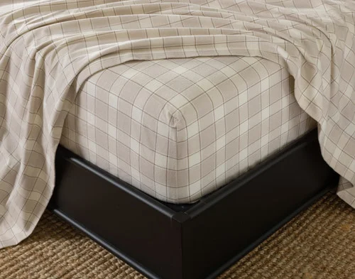 Close-up of the fitted sheet from our Cabin Check Organic Cotton Flannel Sheet Set fitted over a mattress.