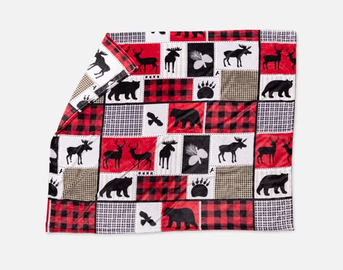 Our Holiday Fleece Throw - Cabin Comfort lying with a fold against a white background.