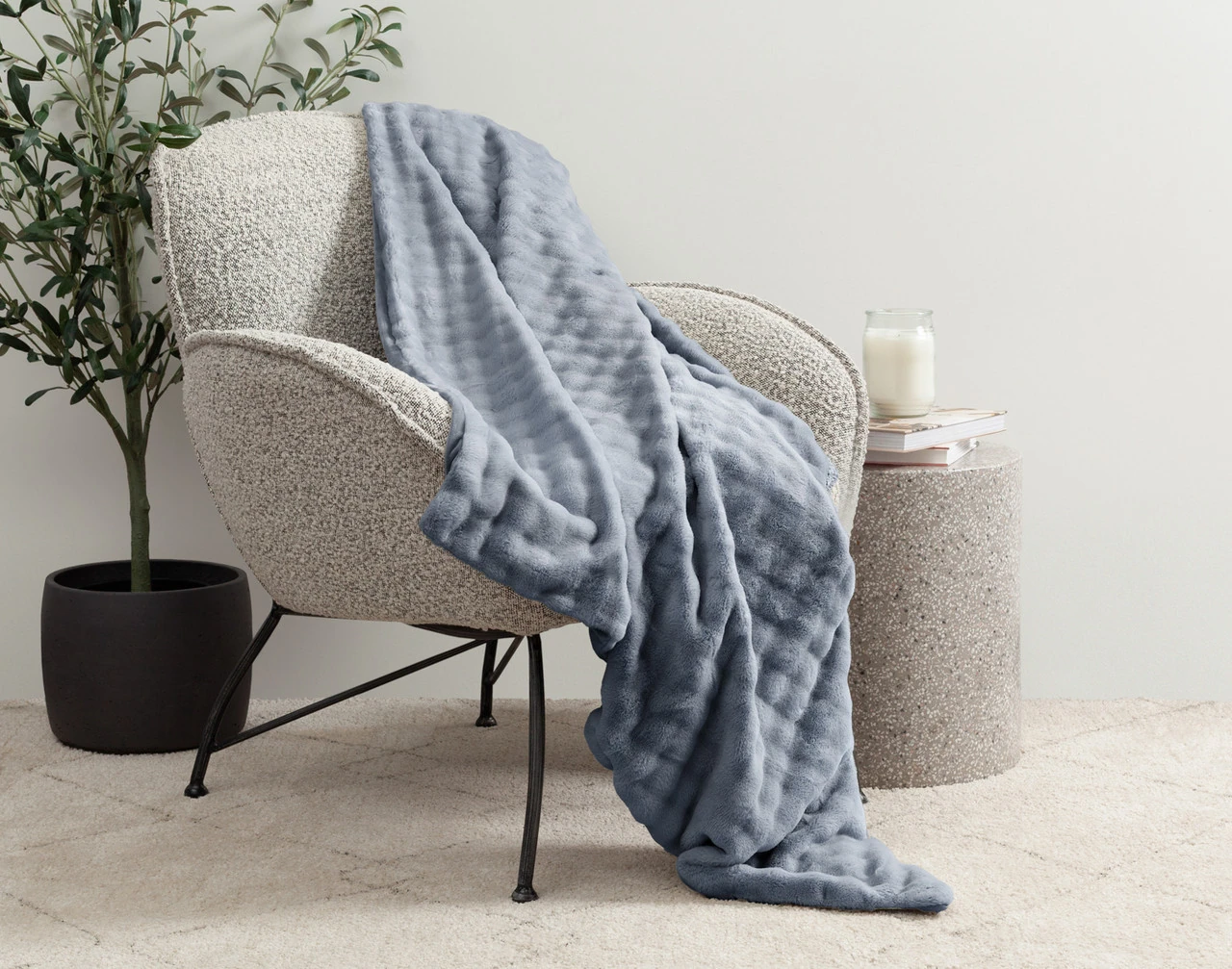 Our Coastal Fog Mini Bubble Throw draped over a grey chair.