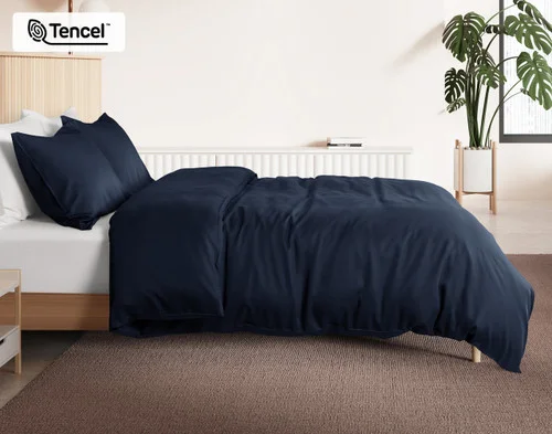 Side view of our Deep Space BeechBliss Duvet Cover dressed over a plain queen bed.