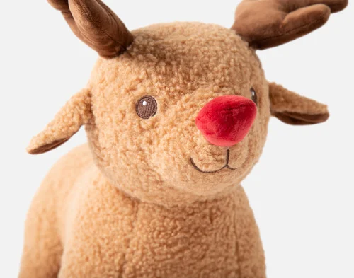 Close-up of our Rudolph Holiday Cushion smiling with his red nose.