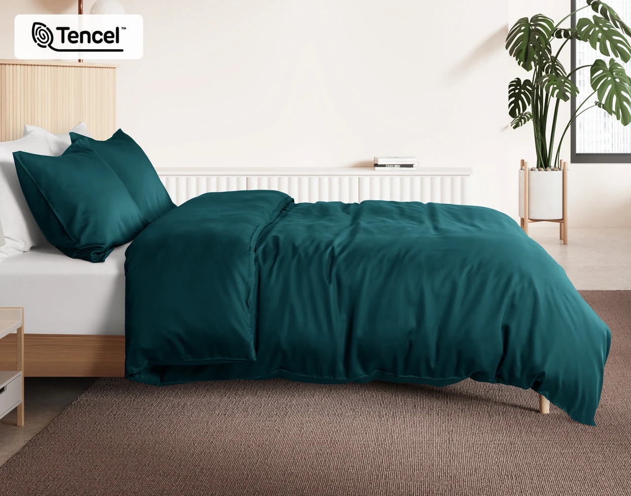 Side view of our Jungle BeechBliss Duvet Cover Set dressed over a plain queen bed.
