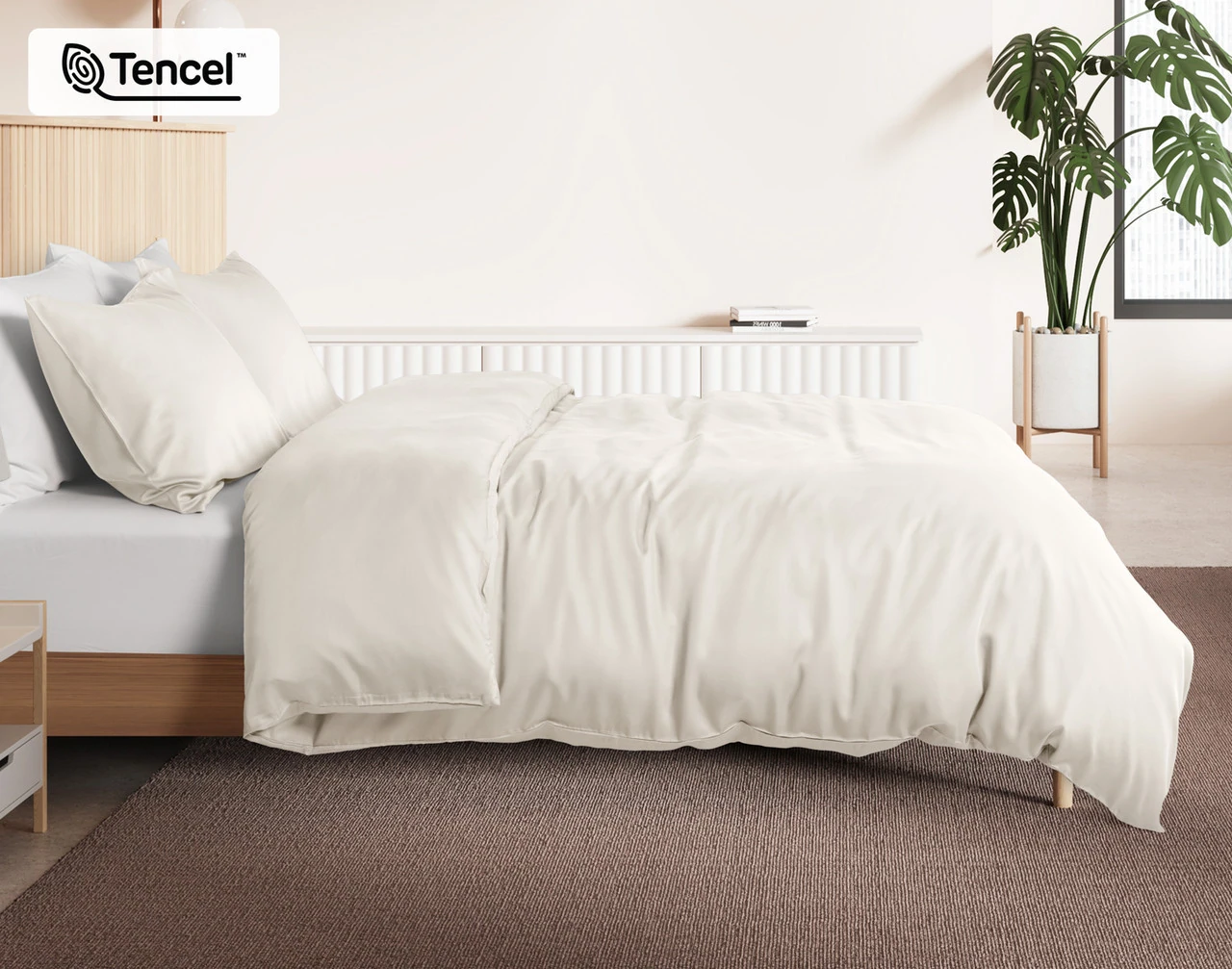 Side view of our Cloud BeechBliss Duvet Cover Set dressed over a plain queen bed.