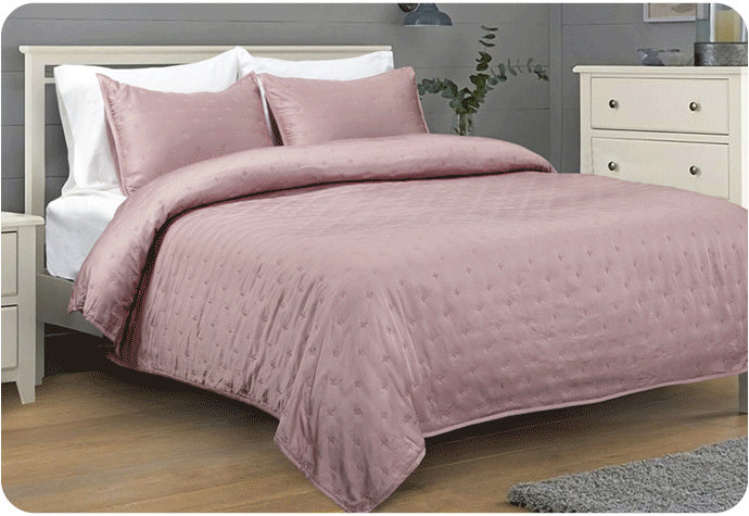 Slideshow gif of various quilt sets dressed over beds.