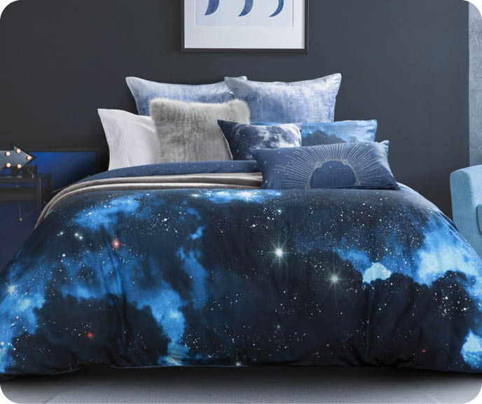 Our Supernova Duvet Cover is an exclusive QE Home design. Boasts a deep space print with shining stars and interstellar clouds and reverses to metallic star pattern. 