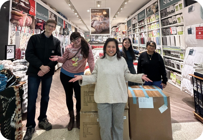 Members of the QE Home team donating to local community organizations