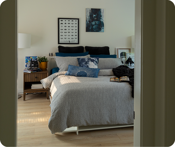 The Ancora Duvet Cover from the Portugal Reserve Collection dressing a bed with blue cushions and a black throw blanket. The Ancora Duvet Cover from the Portugal Reserve Collection dressing a bed with blue cushions and a black throw blanket.