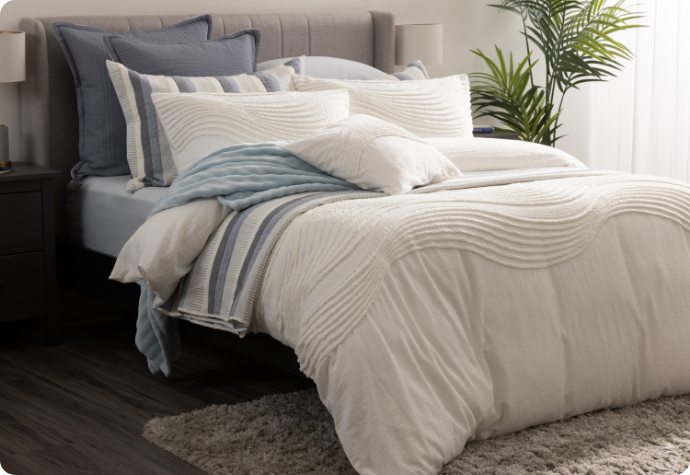 Dressed in Savary Our Savary Duvet Cover dressing a queen bed with blue accessories.