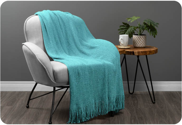 Our new Chenille Throw  in Turquoise on a grey armchair